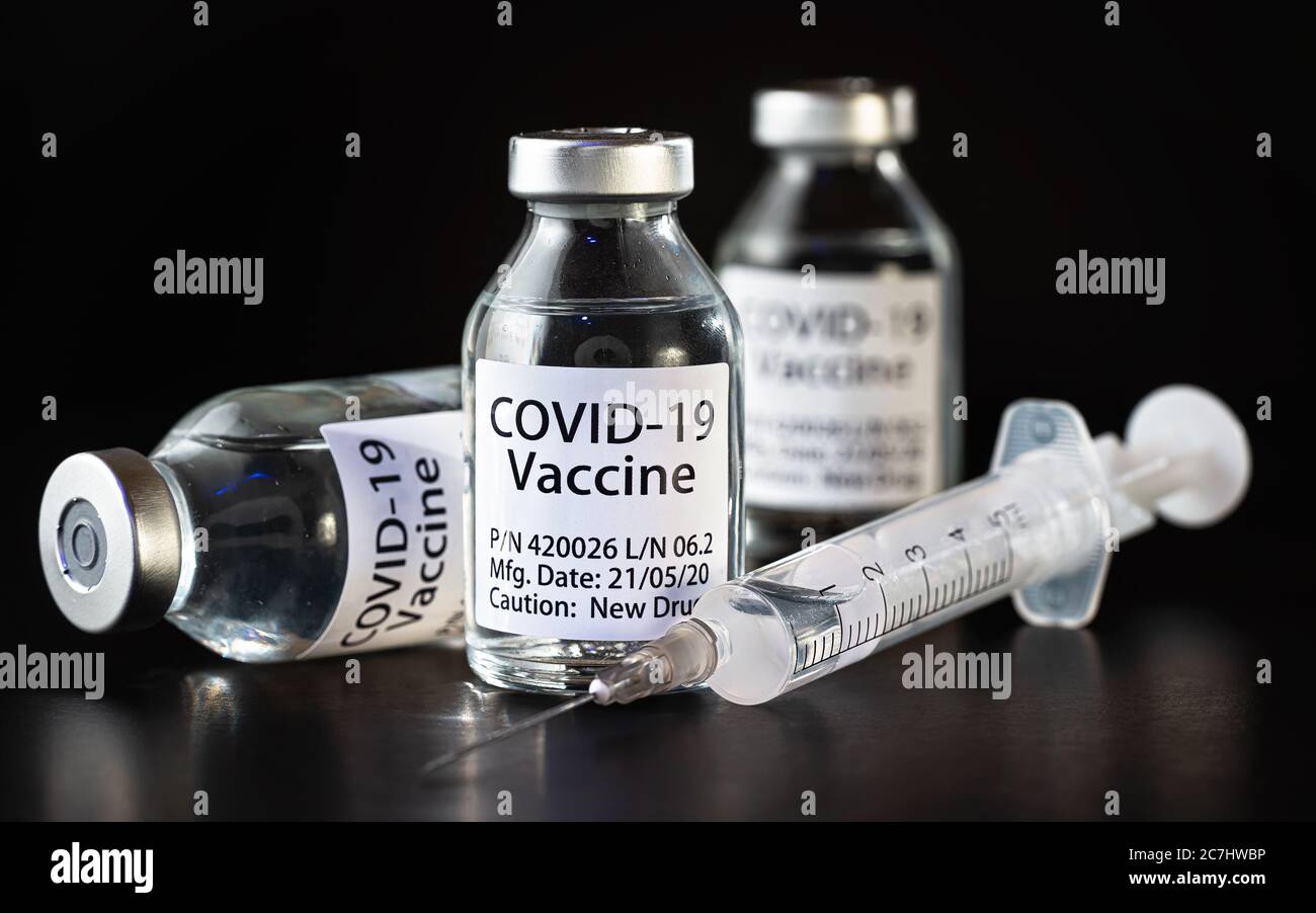Concept de vaccin Covid-19 du coronavirus - trois flacons en verre sur table noire, aiguille de seringue hypodermique près, détail de la fermeture (étiquette propre conception - dat factice Banque D'Images