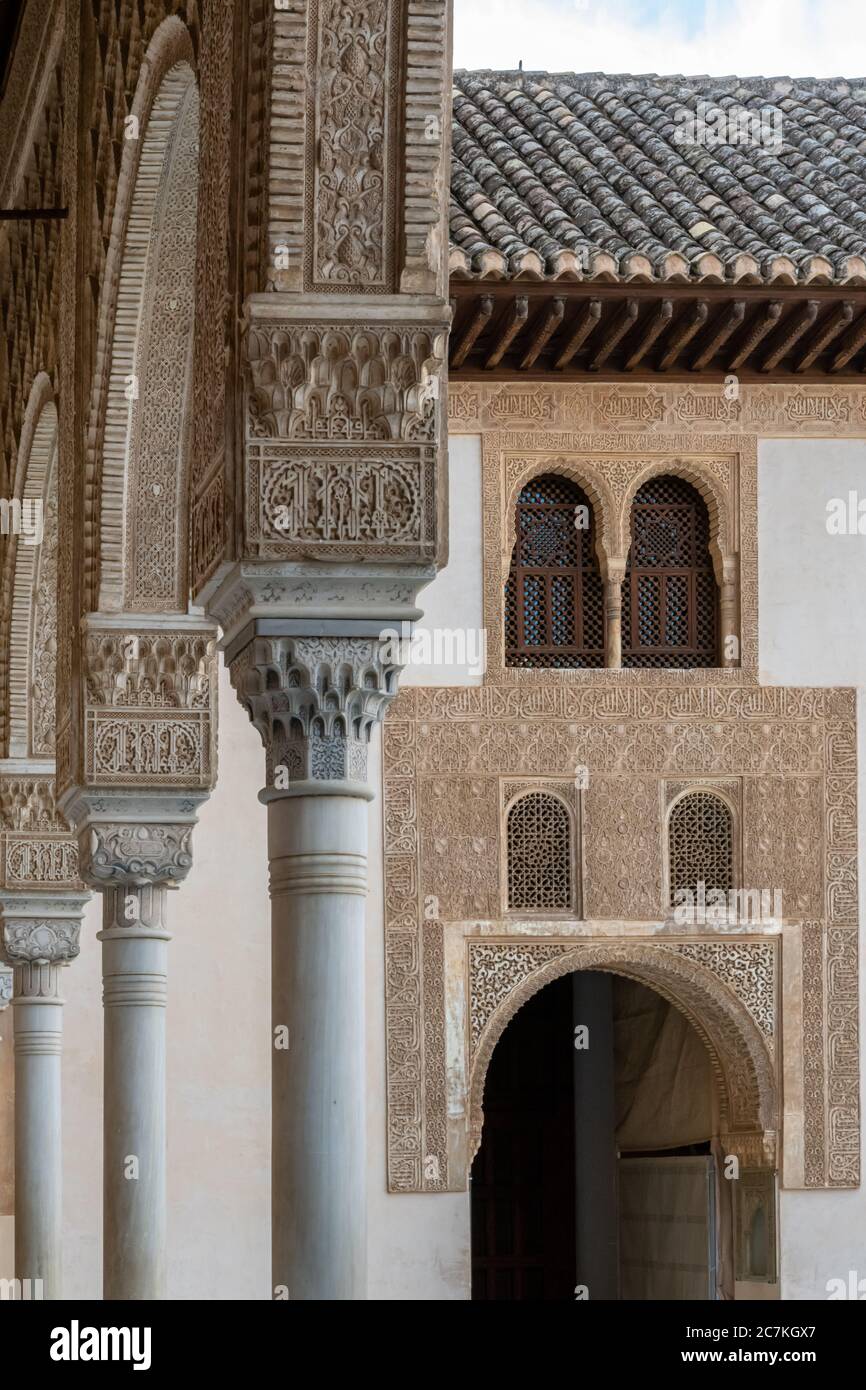 Arches en fer à cheval ornées et décoration arabesque dans la cour des Myrtles de l'Alhambra Banque D'Images