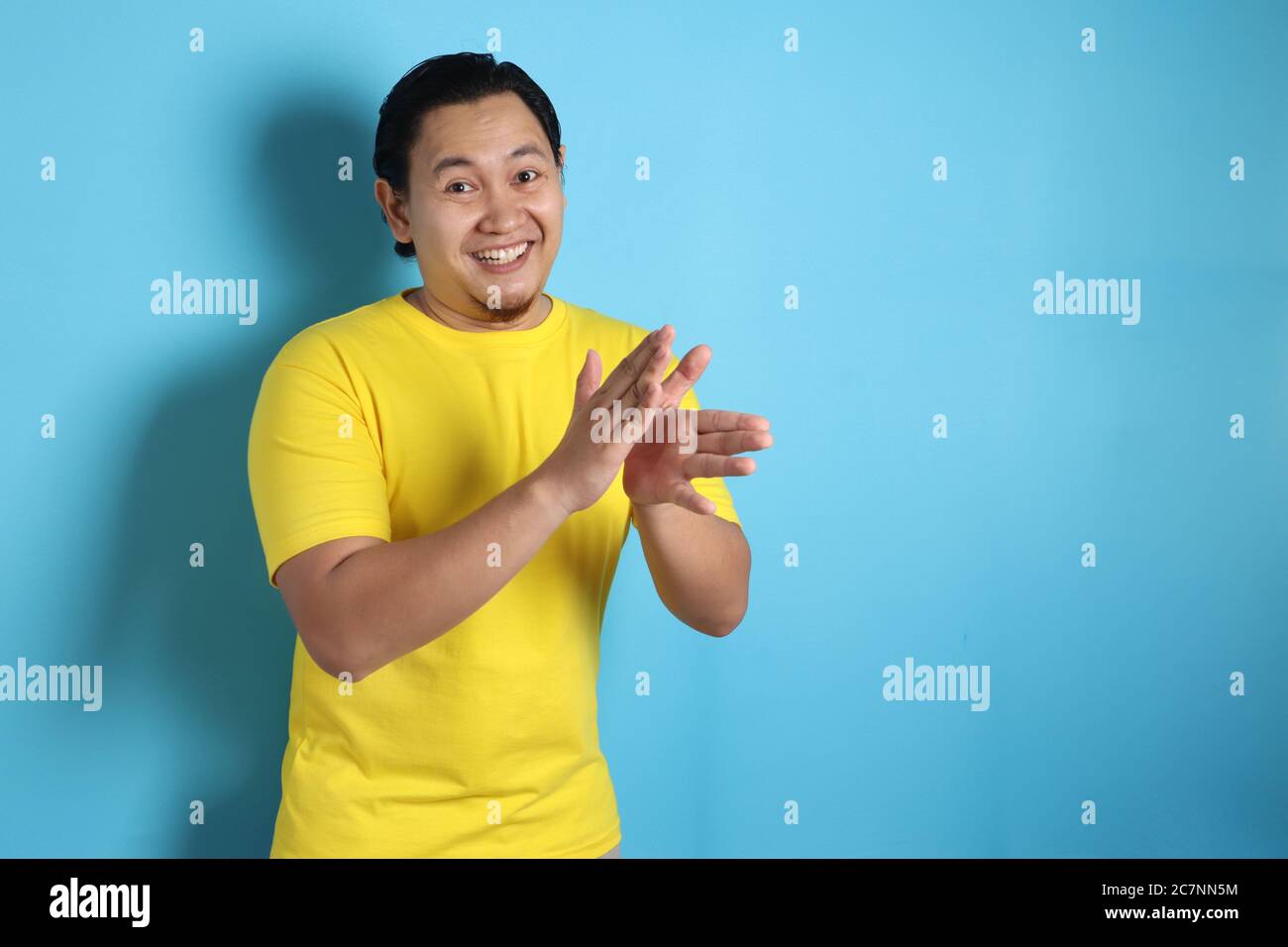 Jeune asiatique portant une chemise blanche, heureux fier clapping geste.sur fond gris, portrait de corps de halfl Banque D'Images