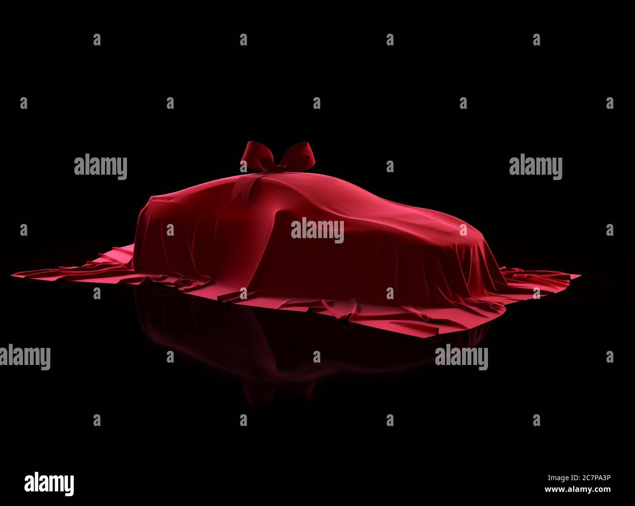 Cadeau voiture recouvert de tissu en velours rouge avec noeud cadeau sur fond noir. Enroulés par un chiffon rouge Banque D'Images