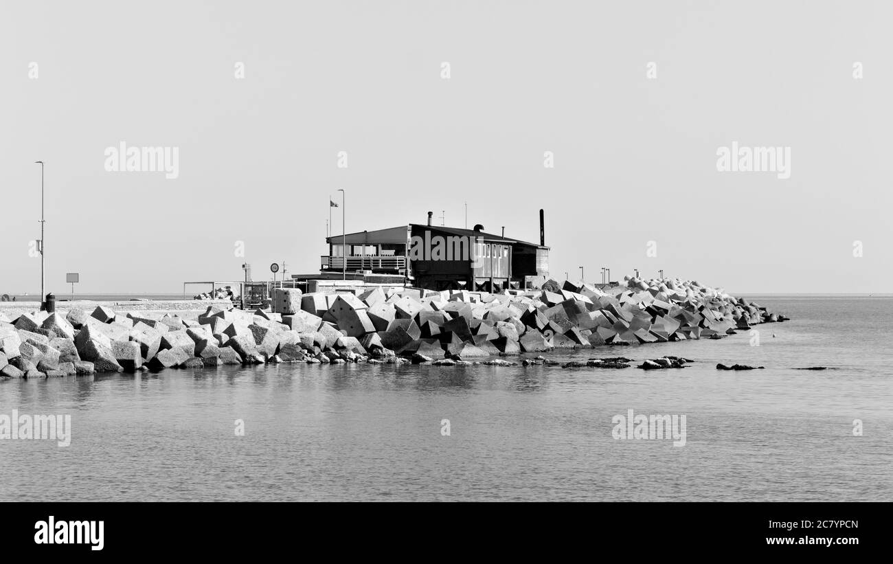 Un ancien bâtiment en bois sur la jetée du port en face des brise-lames de la mer Méditerranée (Pesaro, Italie, Europe) Banque D'Images