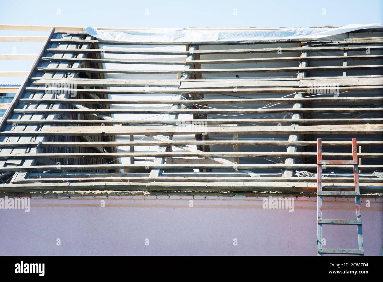 Répare le remplacement de l'ancien toit. Dépose de l'ancien toit et remplacement par tous les nouveaux matériaux. Chantier de construction de toit. Chevrons cassés Banque D'Images