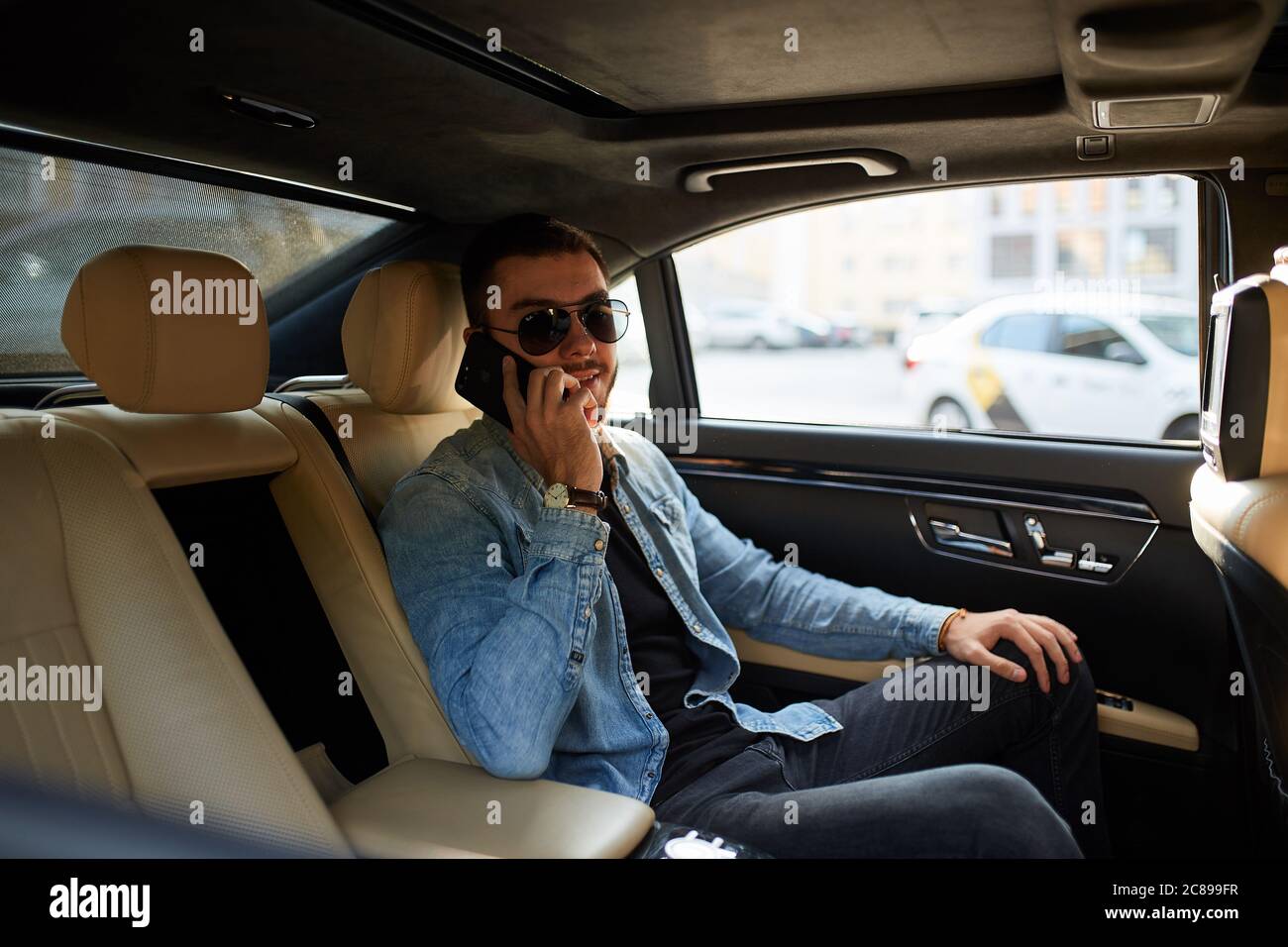 Mafia russe avec smartphone dans la voiture. Gros plan vue latérale photo. Banque D'Images