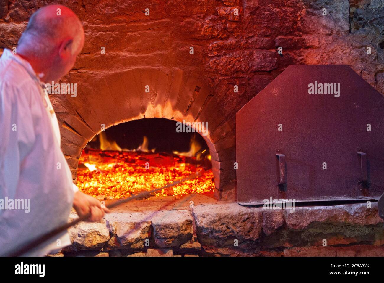 Bazoges-en-Pareds, France - juillet 29 2017 : Baker prépare le four en briques d'un ancien bakehouse pour cuire les foures, un pain rond et aéré de wes Banque D'Images