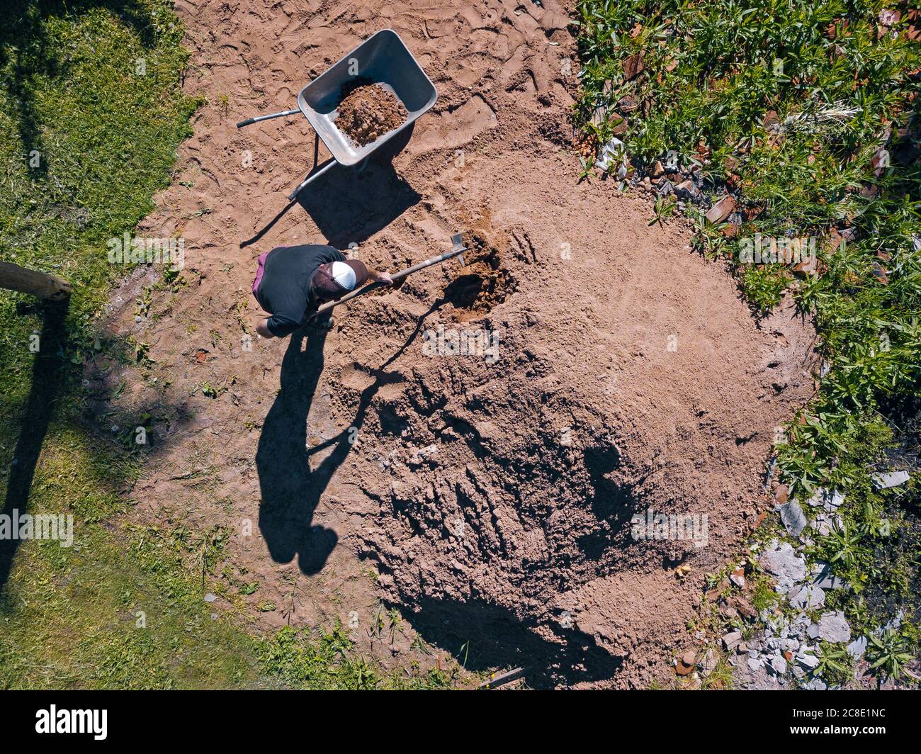 Vue aérienne de l'homme chargé du sable sur la brouette Banque D'Images