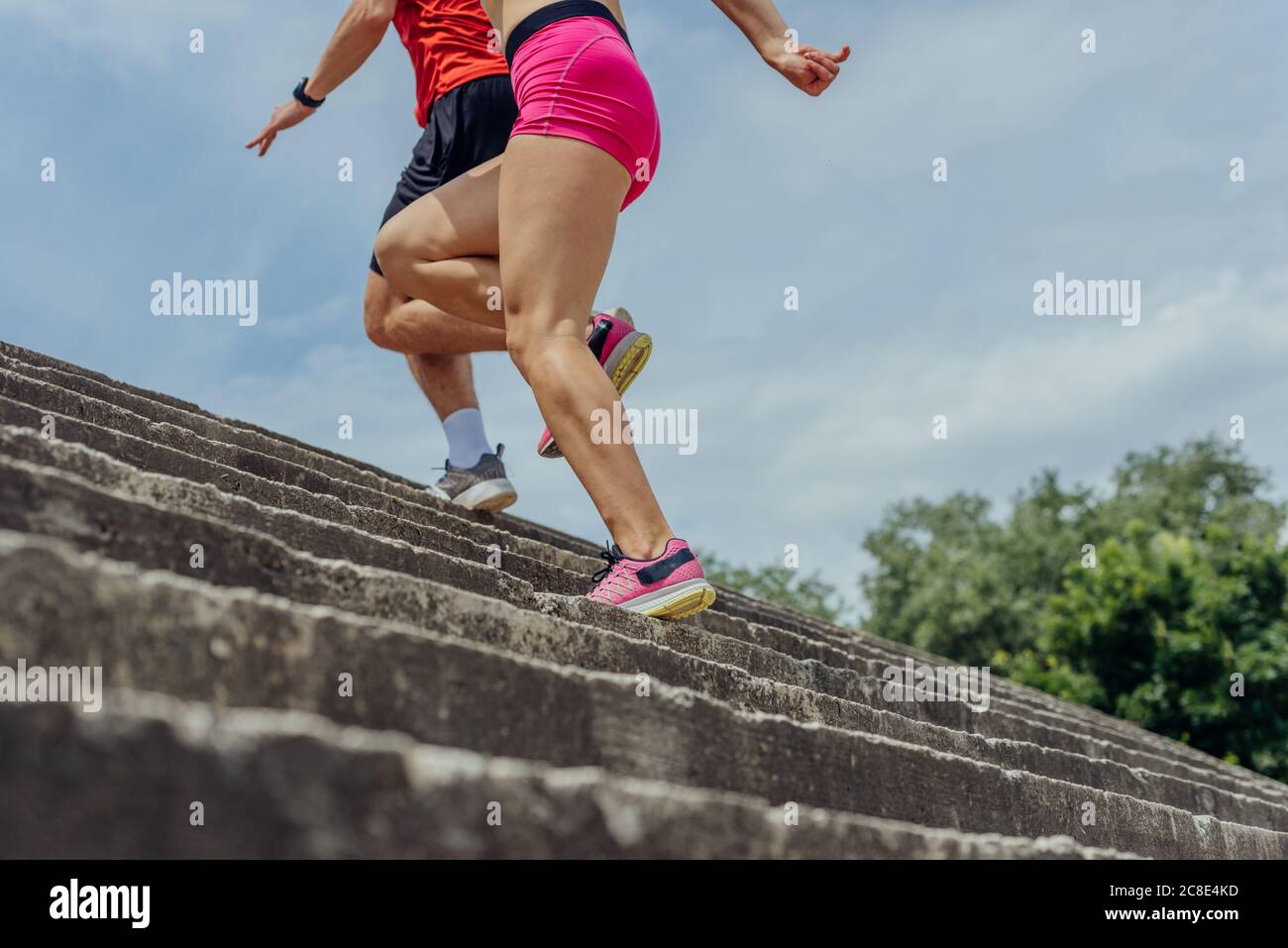 Gros plan et vue basse sous l'angle photo des jambes des athlètes qui s'entraînent dans des escaliers en béton Banque D'Images