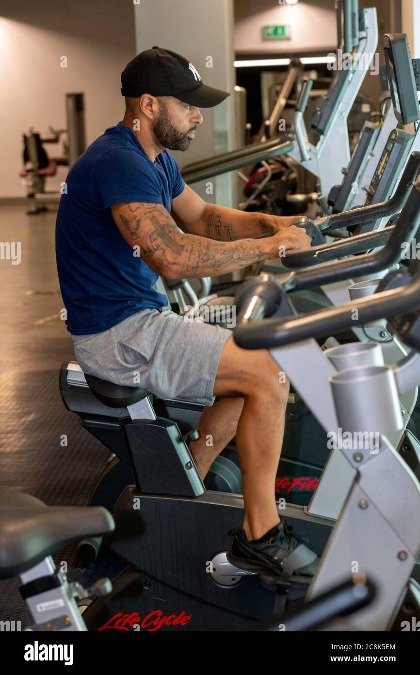 Man on exercise bike in gym Banque D'Images