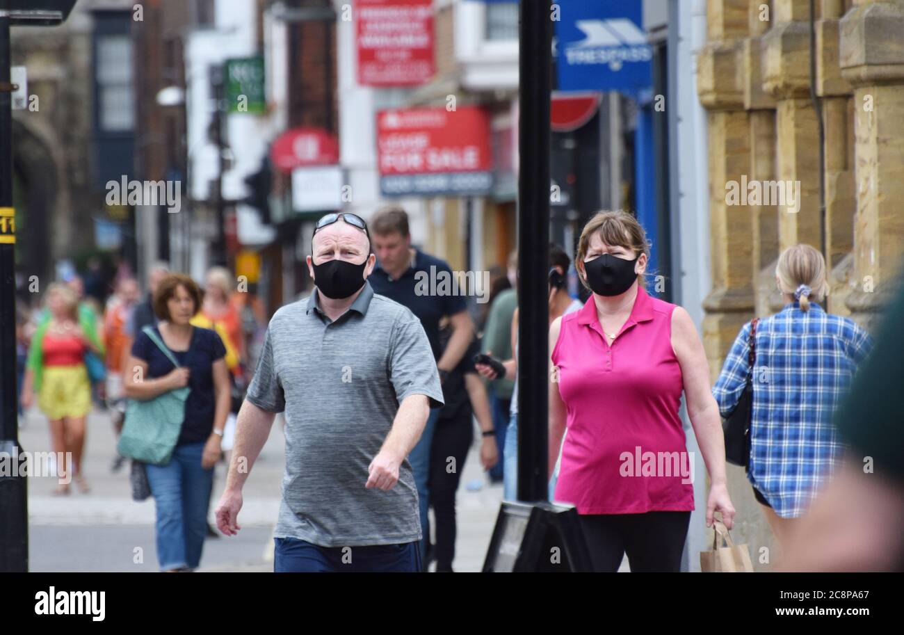 Un homme et une femme en surpoids portant des masques de visage en public en Angleterre suite à une loi adoptée rendant le port de revêtements de visage obligatoire dans les magasins Banque D'Images