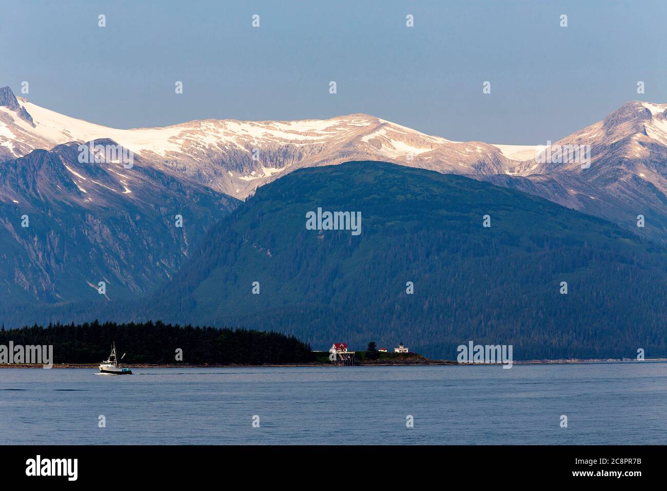 Bateau de pêche dans la baie d'Auke avec montagne de neige en arrière-plan, Alaska Banque D'Images