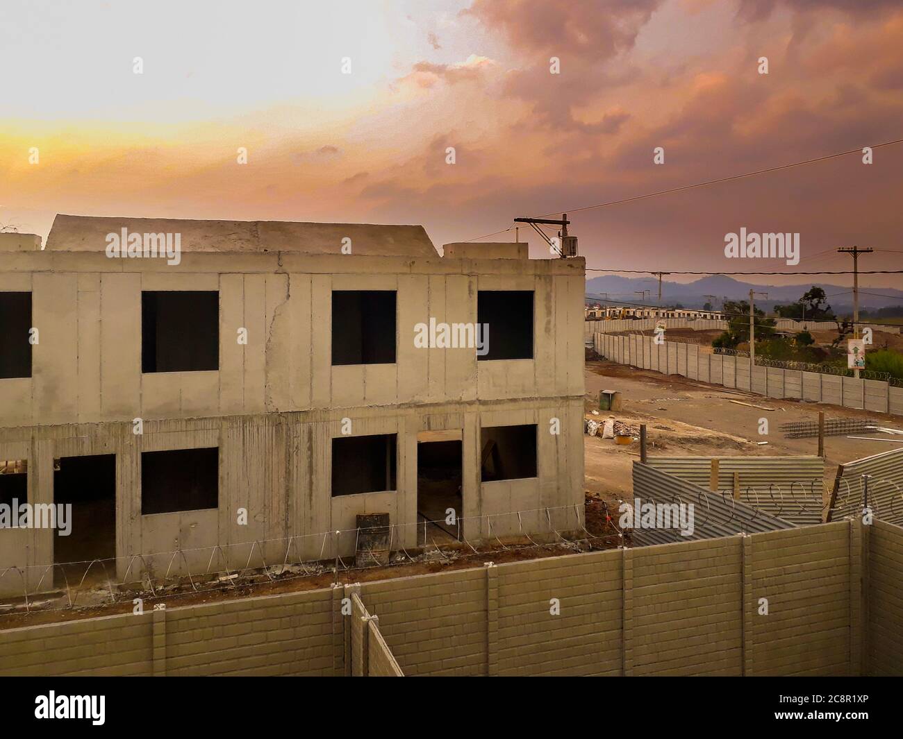 Construction en série de maisons en béton coulé sur place, petite maison familiale au Guatemala, coucher de soleil spectaculaire. Banque D'Images