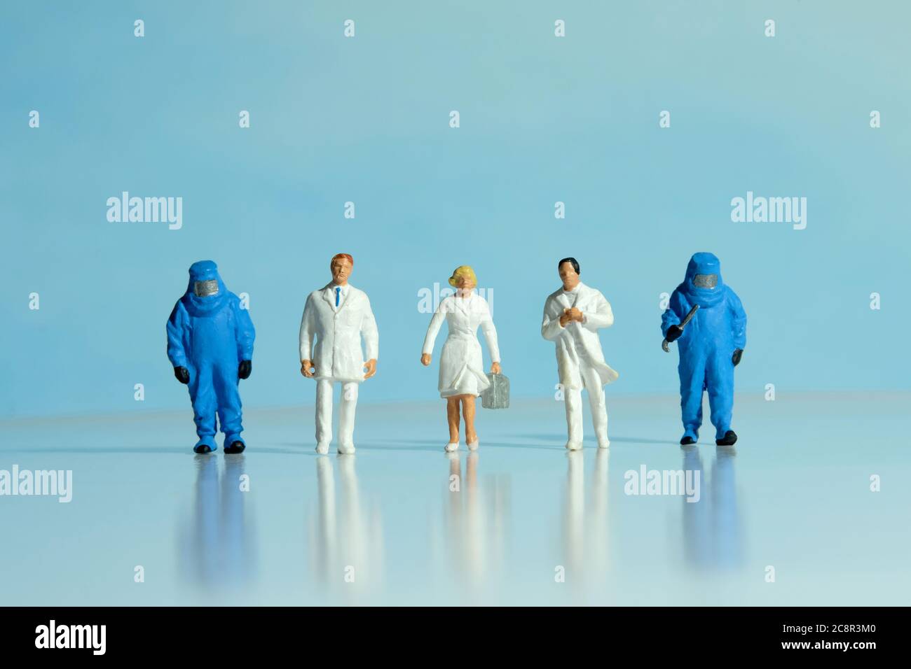 Vue de face des médecins, des infirmières et des travailleurs médicaux portent un costume bleu noisette qui se présente au travail. Photographie conceptuelle de personnes miniatures. Banque D'Images