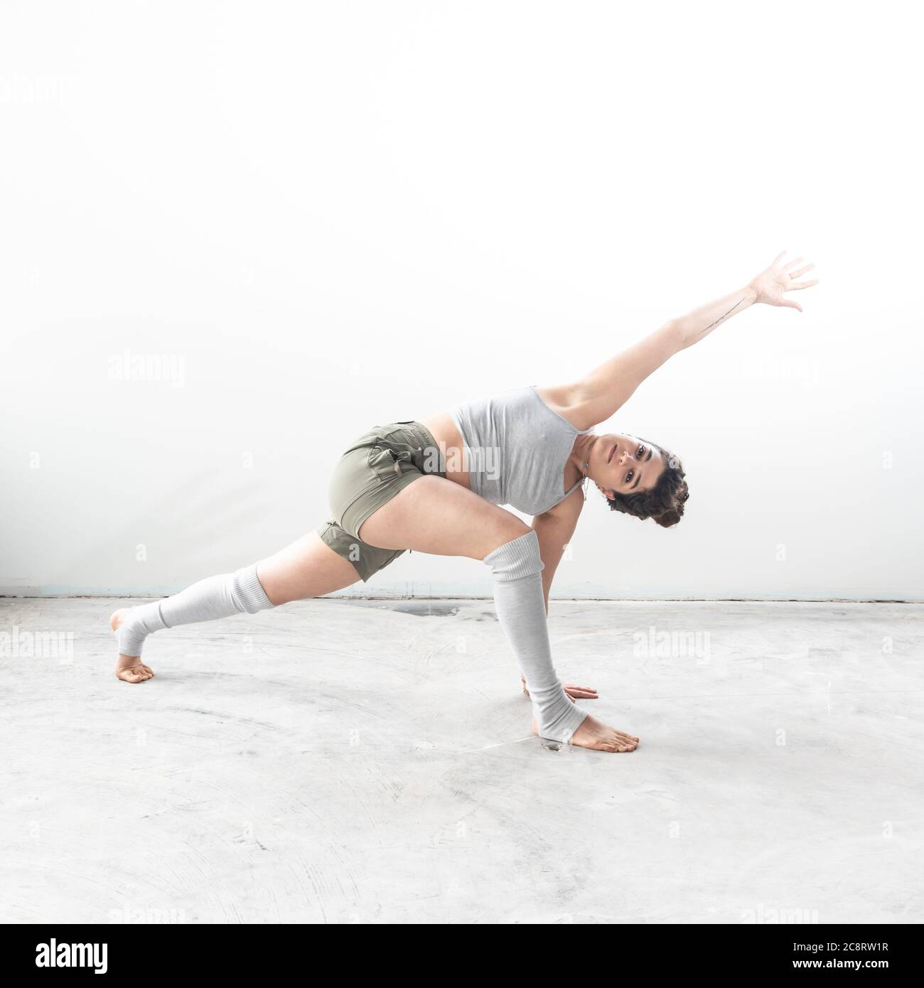 Un entraîneur de fitness s'étire en studio Banque D'Images