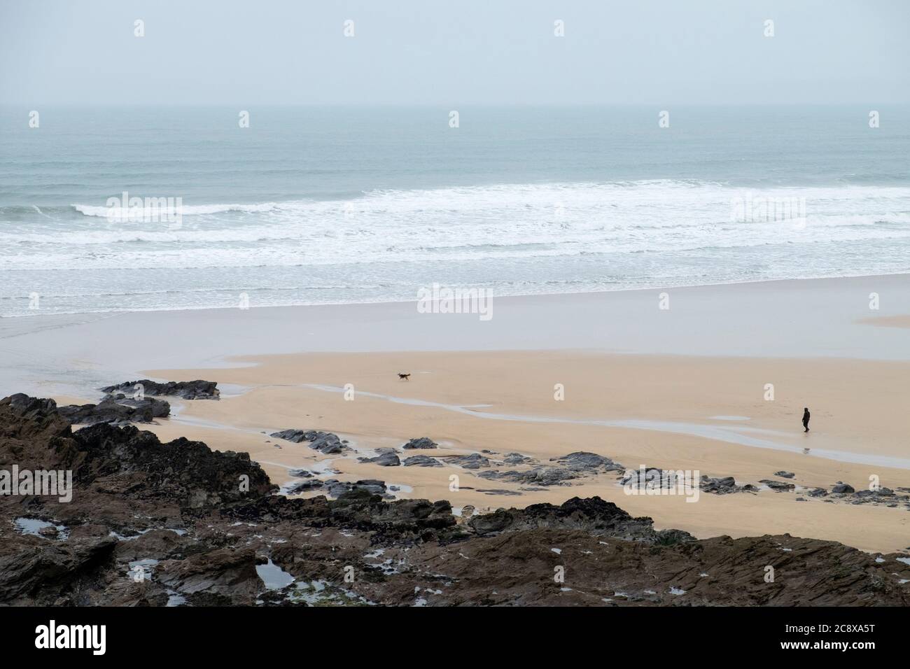 Marcheurs seuls sur la plage de Fistral, Newquay, Cornwall Banque D'Images