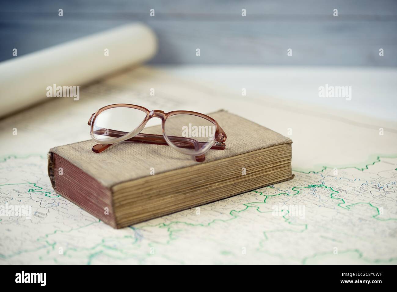 Vieux livres et lunettes de lecture sur la carte antique Banque D'Images