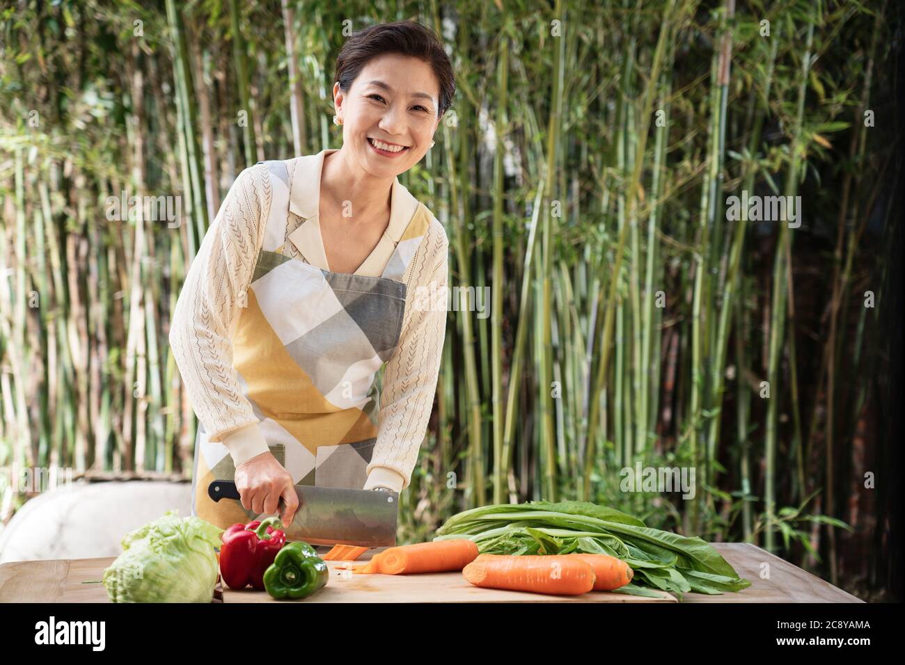 La cour hacher des légumes chez les femmes de la vie moyenne Banque D'Images