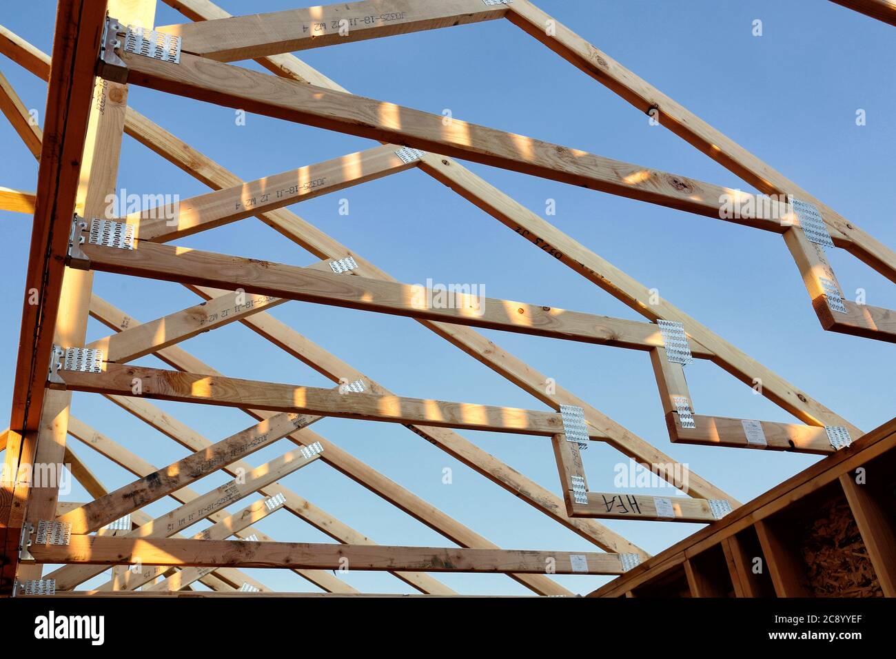 Une vue ouverte sur les fermes de toit en bois sur une maison en construction. Banque D'Images