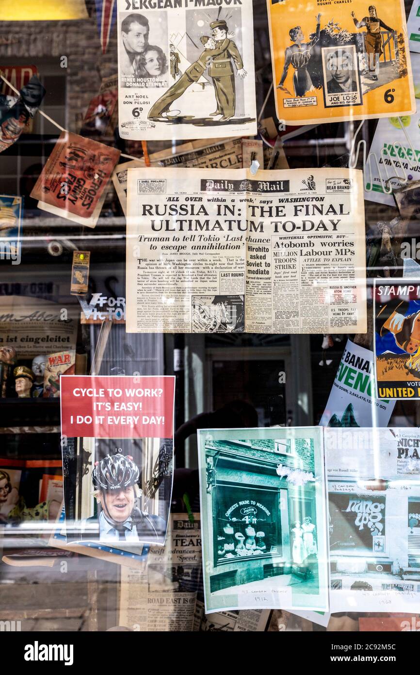Affiches et coupures de journaux accrochées dans une vitrine à Camden passage à Angel, Islington, Londres, Royaume-Uni Banque D'Images