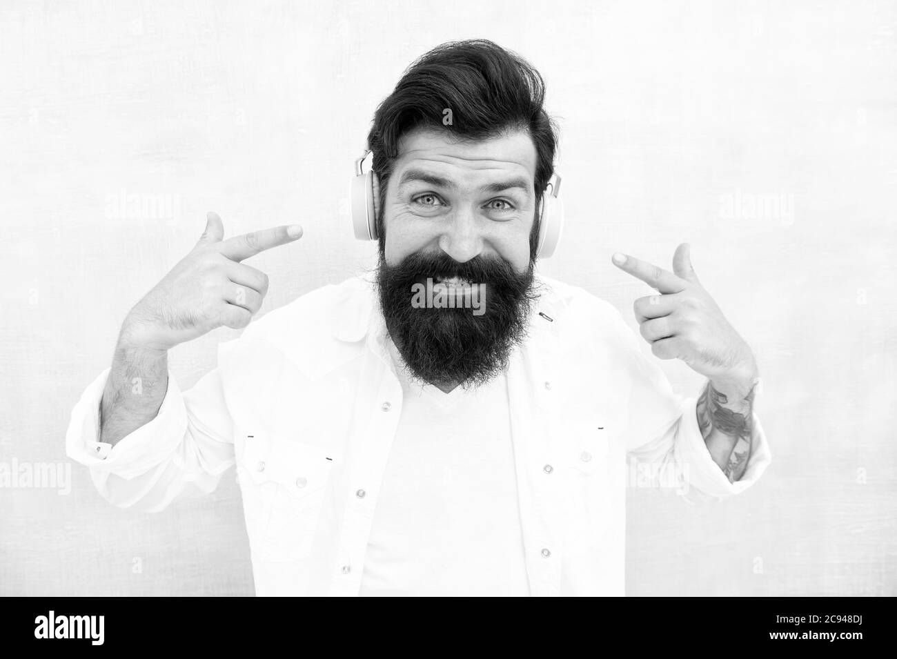 Profitez de chaque note. Technologie d'annulation active du bruit. Casque stéréo Hipster pour écouter de la musique. Casque sans fil moderne. Pistes de musique de danse électroniques. Musique instrumentale. Casque homme barbu. Banque D'Images