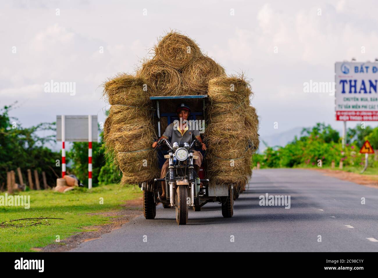 Dalat, Lam Dong, Vietnam - juillet 2020 : un homme vietnamien transporte des piles de foin Banque D'Images