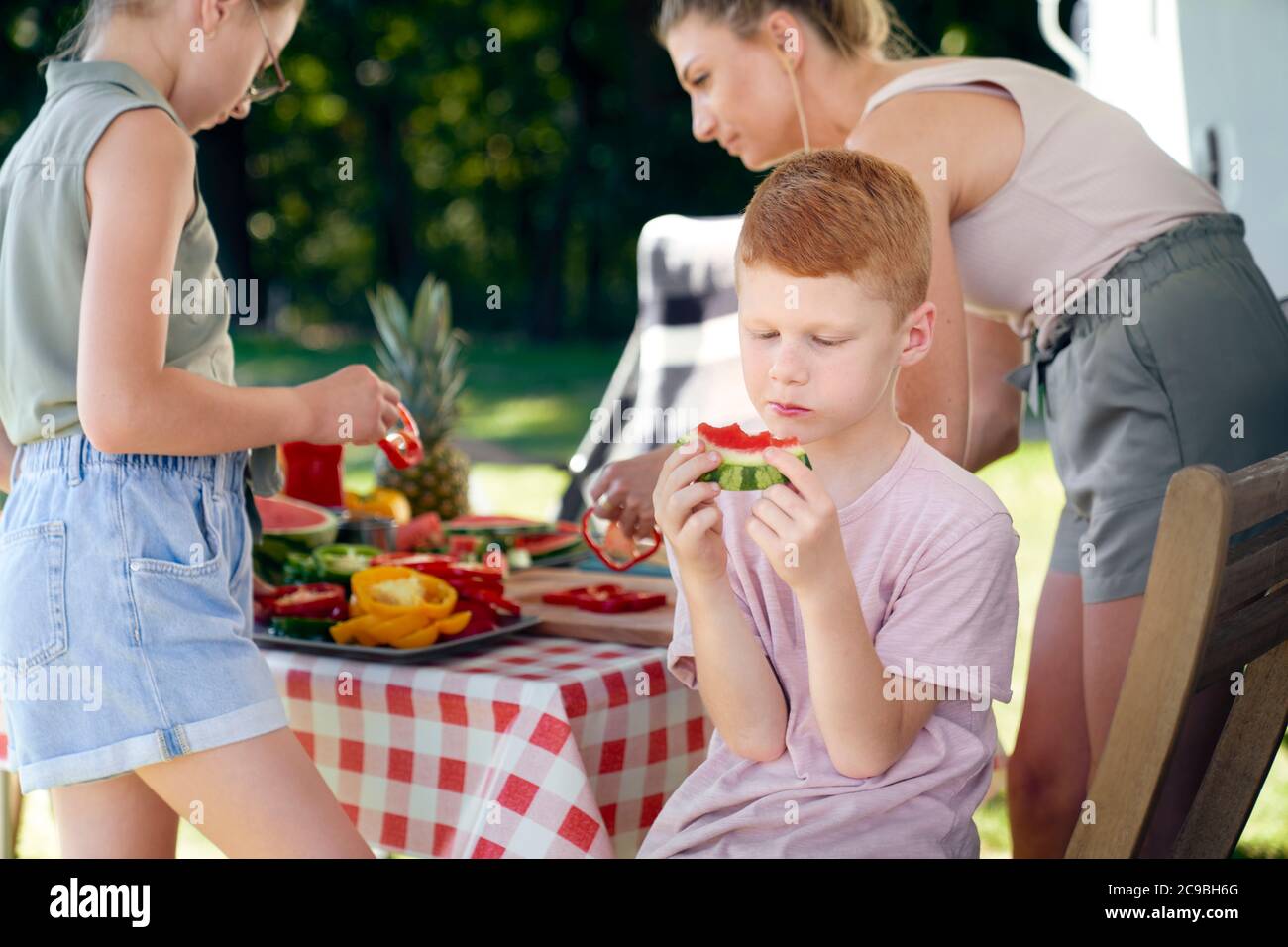 Garçon et sa famille en vacances au camping Banque D'Images