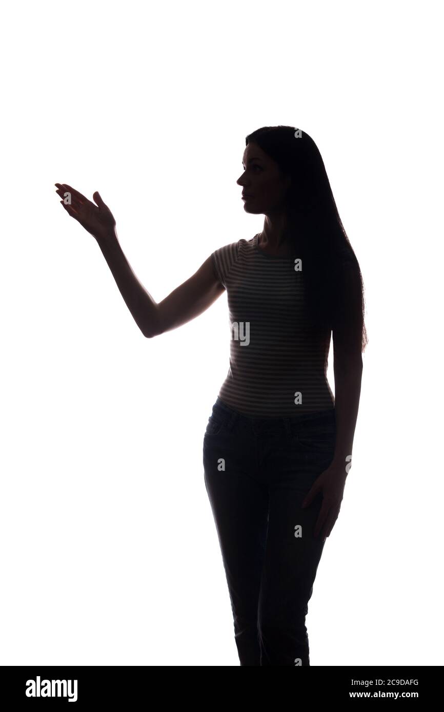 La jeune femme en costume montre son index, main vers l'avant - silhouette Banque D'Images