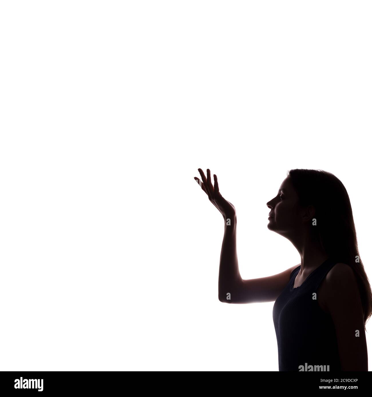 La jeune femme montre son index, main vers l'avant - silhouette Banque D'Images