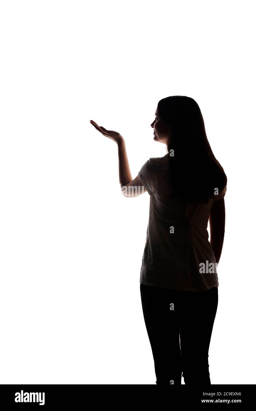 La jeune femme montre son index, main vers l'avant - silhouette Banque D'Images