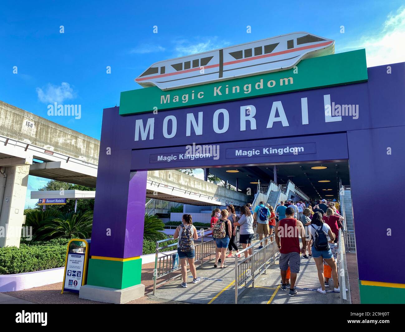 Orlando,FL/USA-7/25/20: Les personnes portant un masque de visage et des distances sociales en attendant dans la file d'attente pour se rendre sur le monorail à Walt Disney World Resorts in Banque D'Images