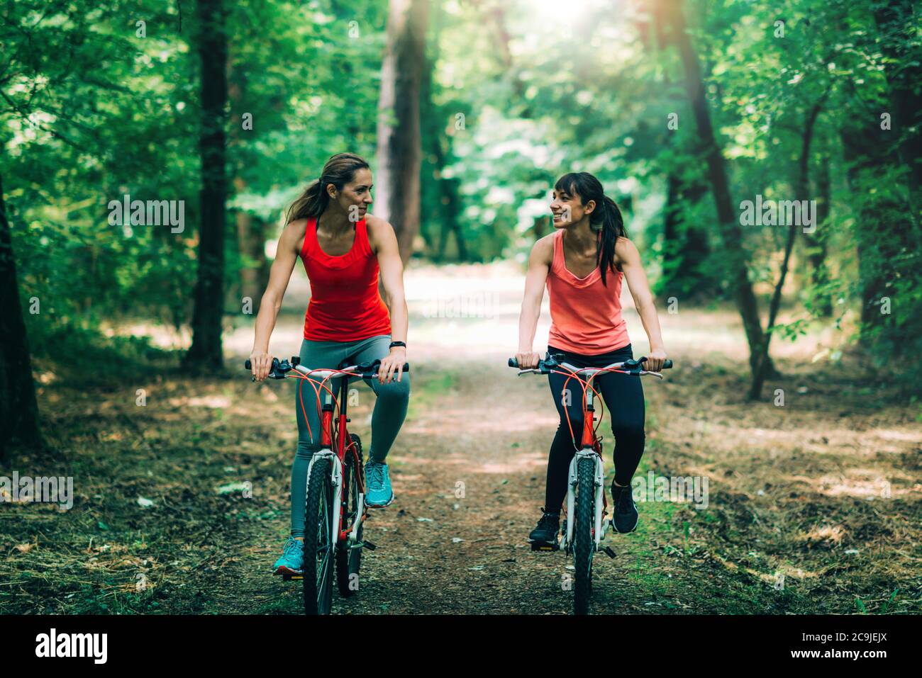 Des amies qui se rassemblent en vélo dans le parc. Banque D'Images