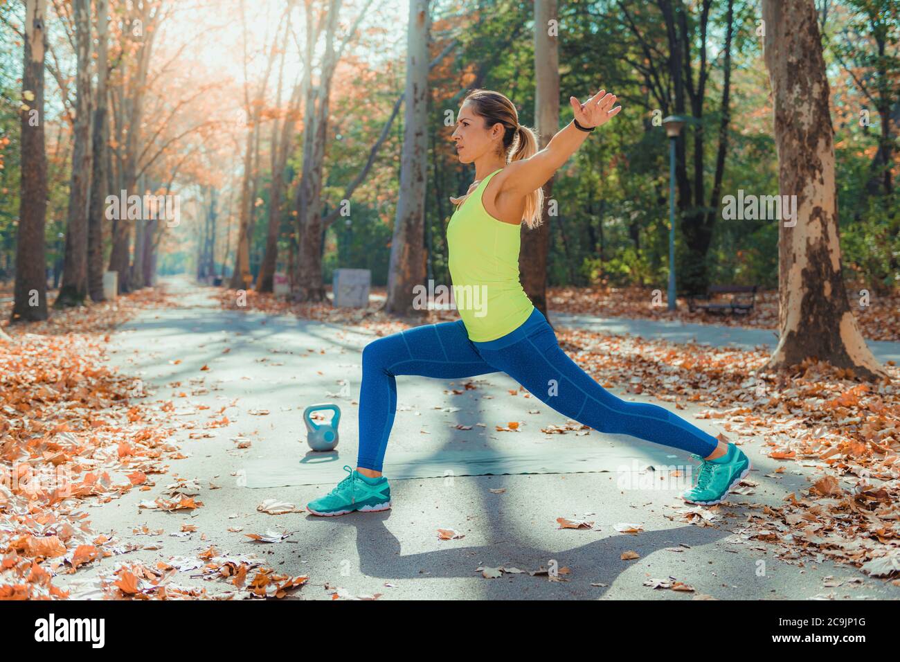 Woman stretching dans le parc. Banque D'Images