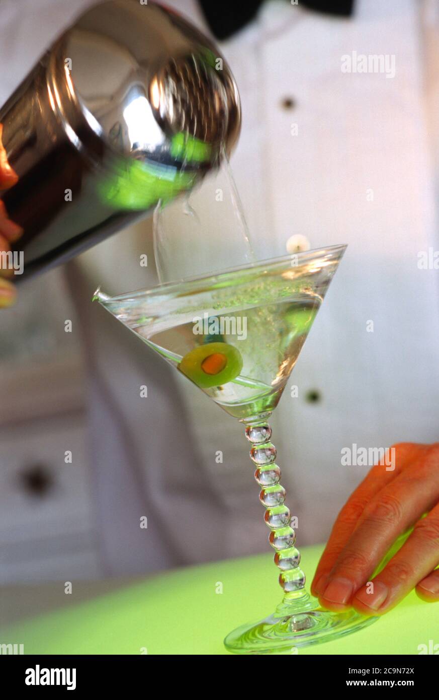 Bartender verse un martini d'un shaker à cocktail, USA Banque D'Images