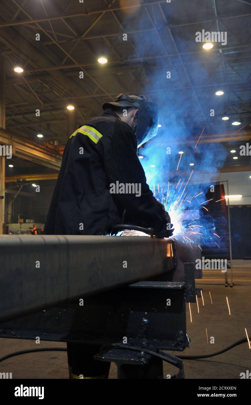 le soudeur électrique prépare de l'acier à l'usine. Banque D'Images