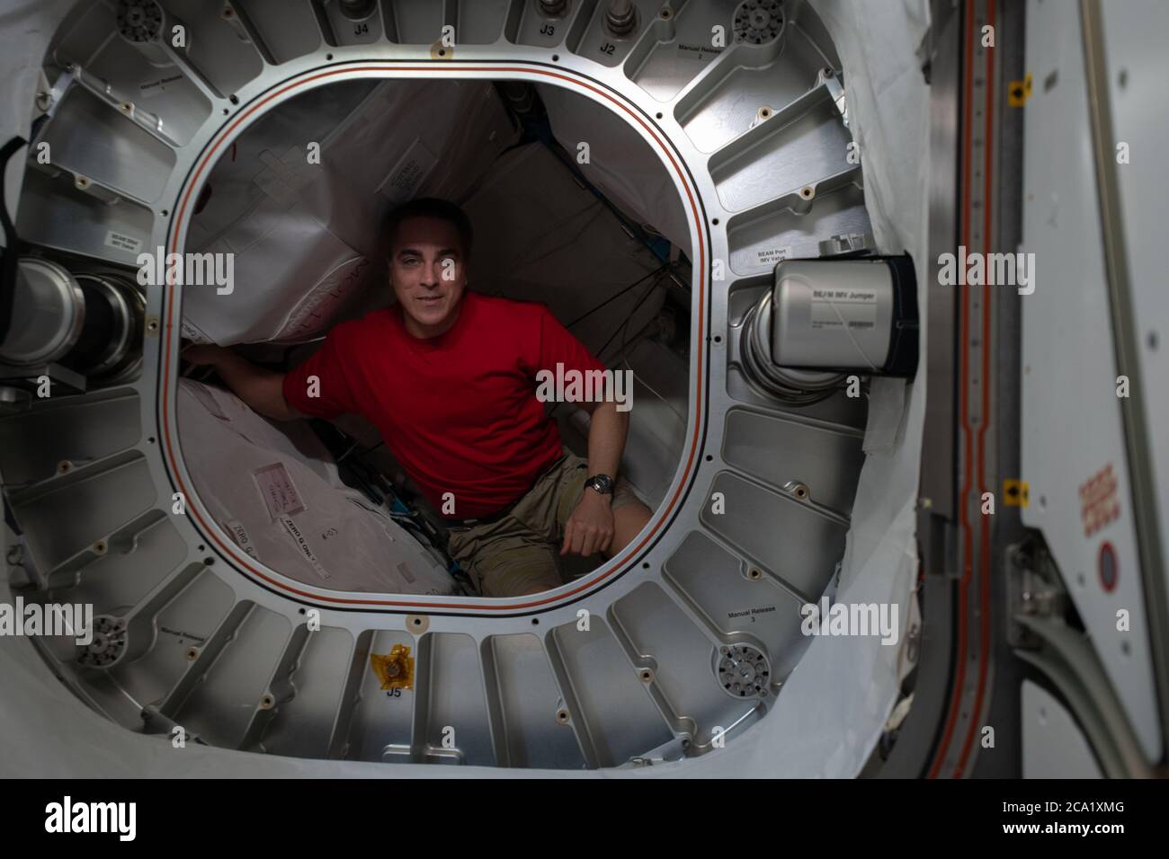 Le commandant de l'expédition 63 de la NASA, Chris Cassidy, récupère des filtres à charbon dans le module aérospatial expansible Bigelow à bord de la Station spatiale internationale le 16 juin 2020 à Earth Orbit. Banque D'Images