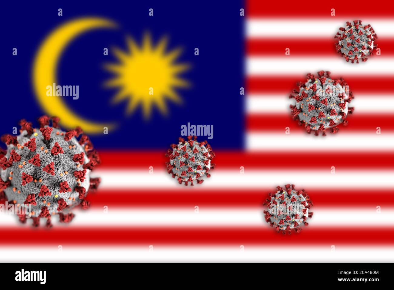 Concept de coronavirus ou de particules Covid-19 qui éclipsent le drapeau flou de la Malaisie en arrière-plan. Banque D'Images