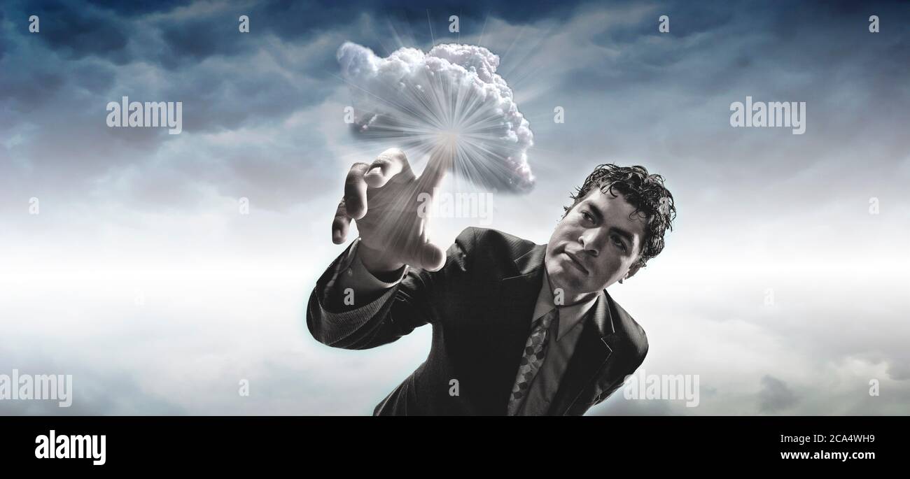 Homme touchant un nuage avec le doigt Banque D'Images