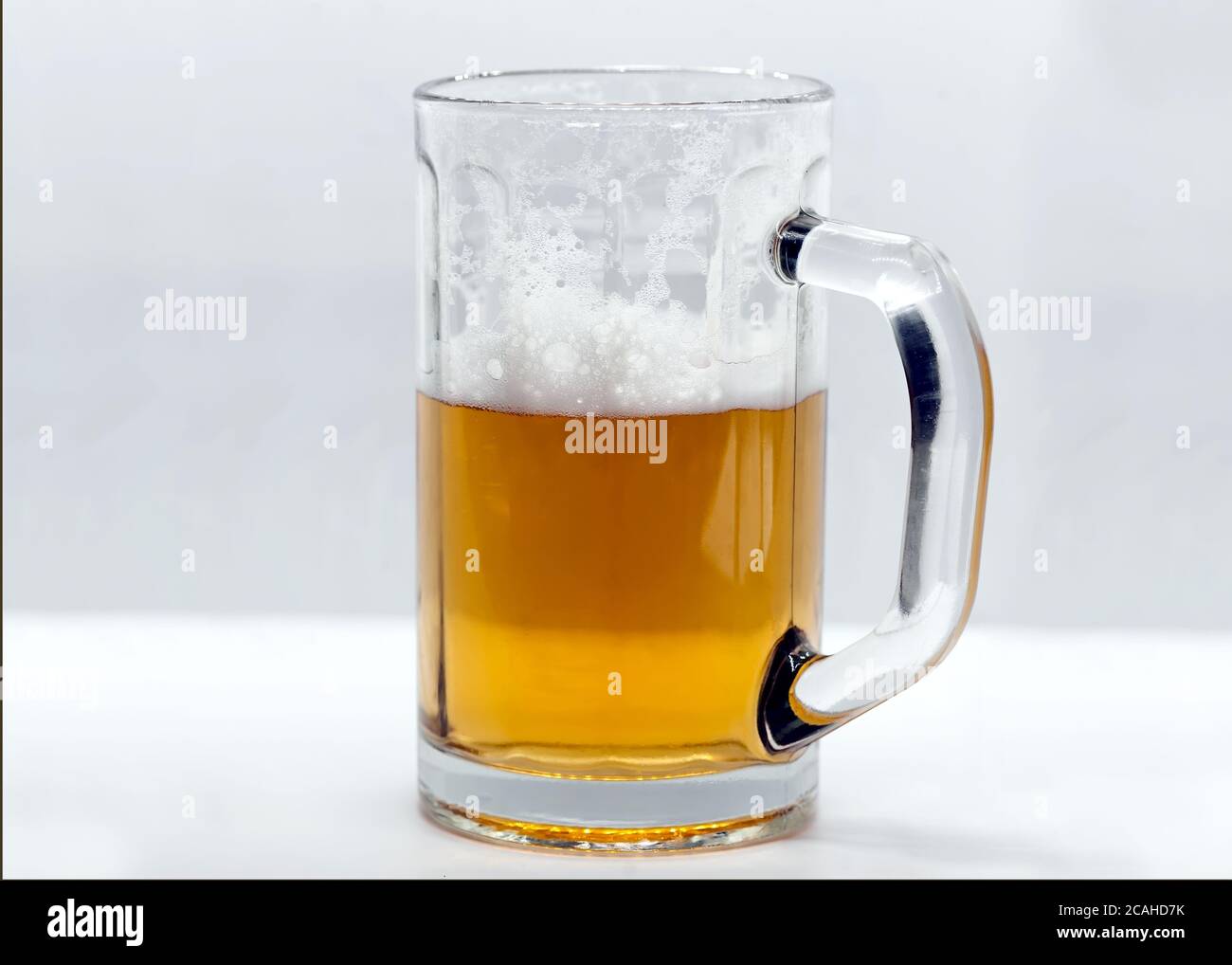 Tasse en verre de bière avec mousse Banque D'Images