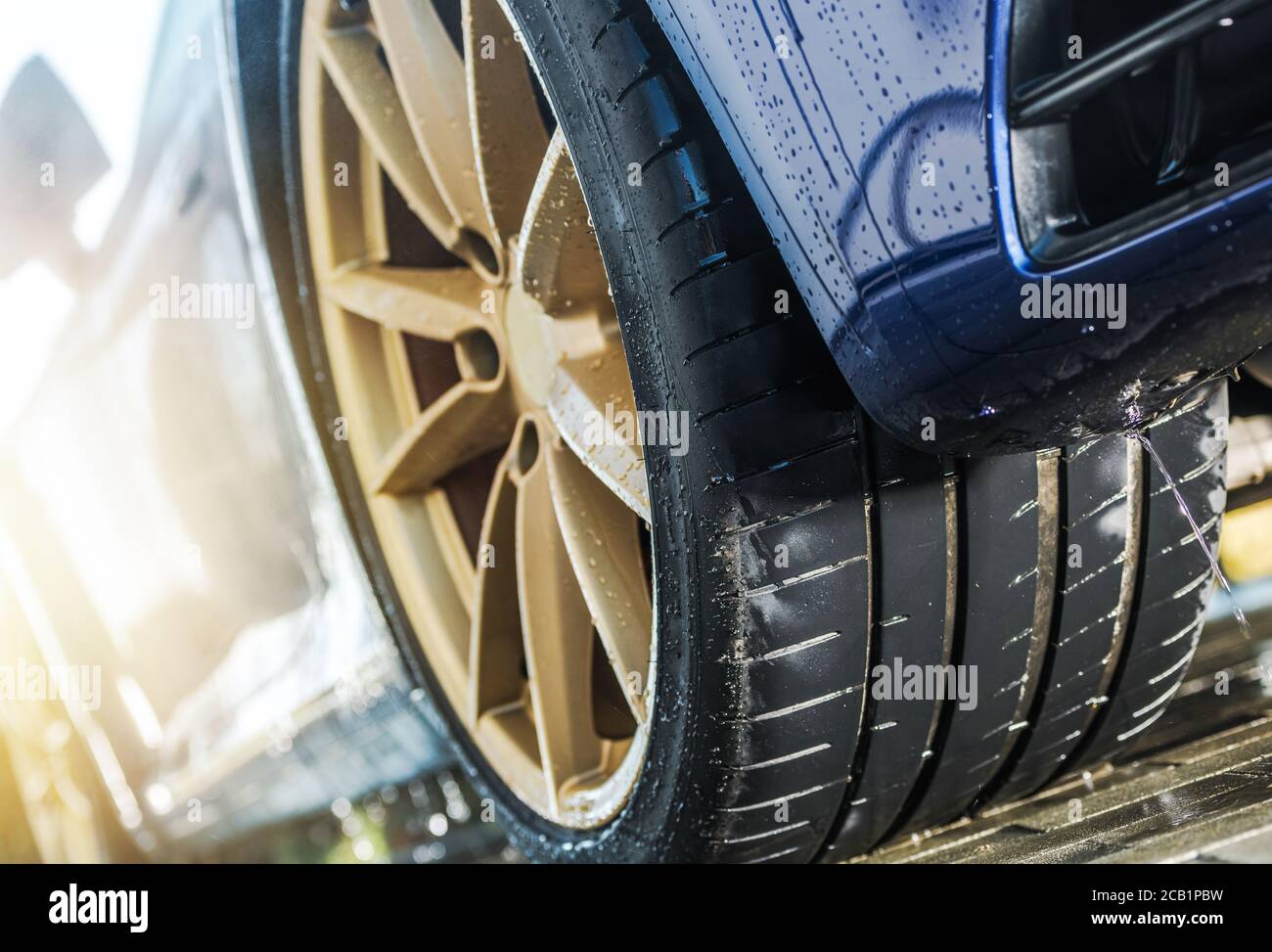 Concept d'affaires du lavage automatique de voiture moderne en action rinçage de véhicule de sport avec de l'eau. Banque D'Images