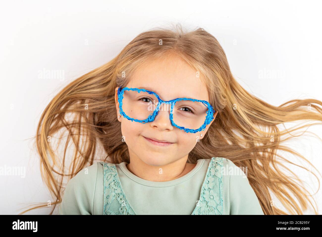 Jolie petite fille blonde avec lunettes 3d en plastique sur fond blanc.  Bannière avec espace de copie, maquette, modèle. Retour à l'école après  Covid-19 Photo Stock - Alamy