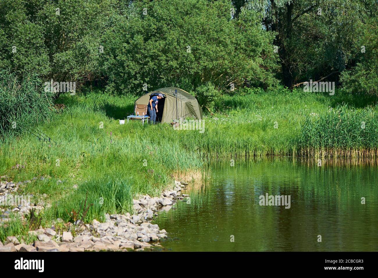 Un pêcheur à la ligne a installé un camp sur les rives de la rivière Elbe Banque D'Images