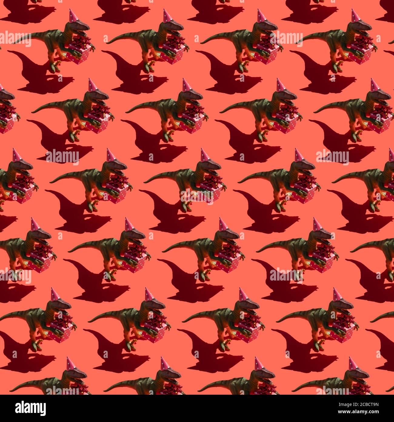 Dinosaure avec motif boîte cadeau sur fond rouge Banque D'Images