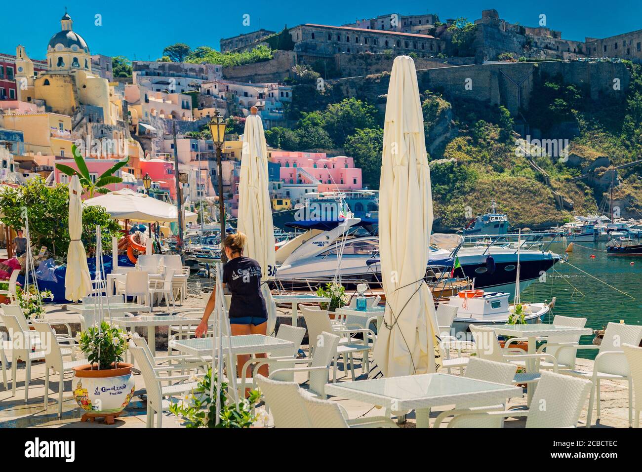 PROCIDA (NA), ITALIE - 30 JUIN 2020 : bateaux amarrés flottant dans le port devant le restaurant Banque D'Images