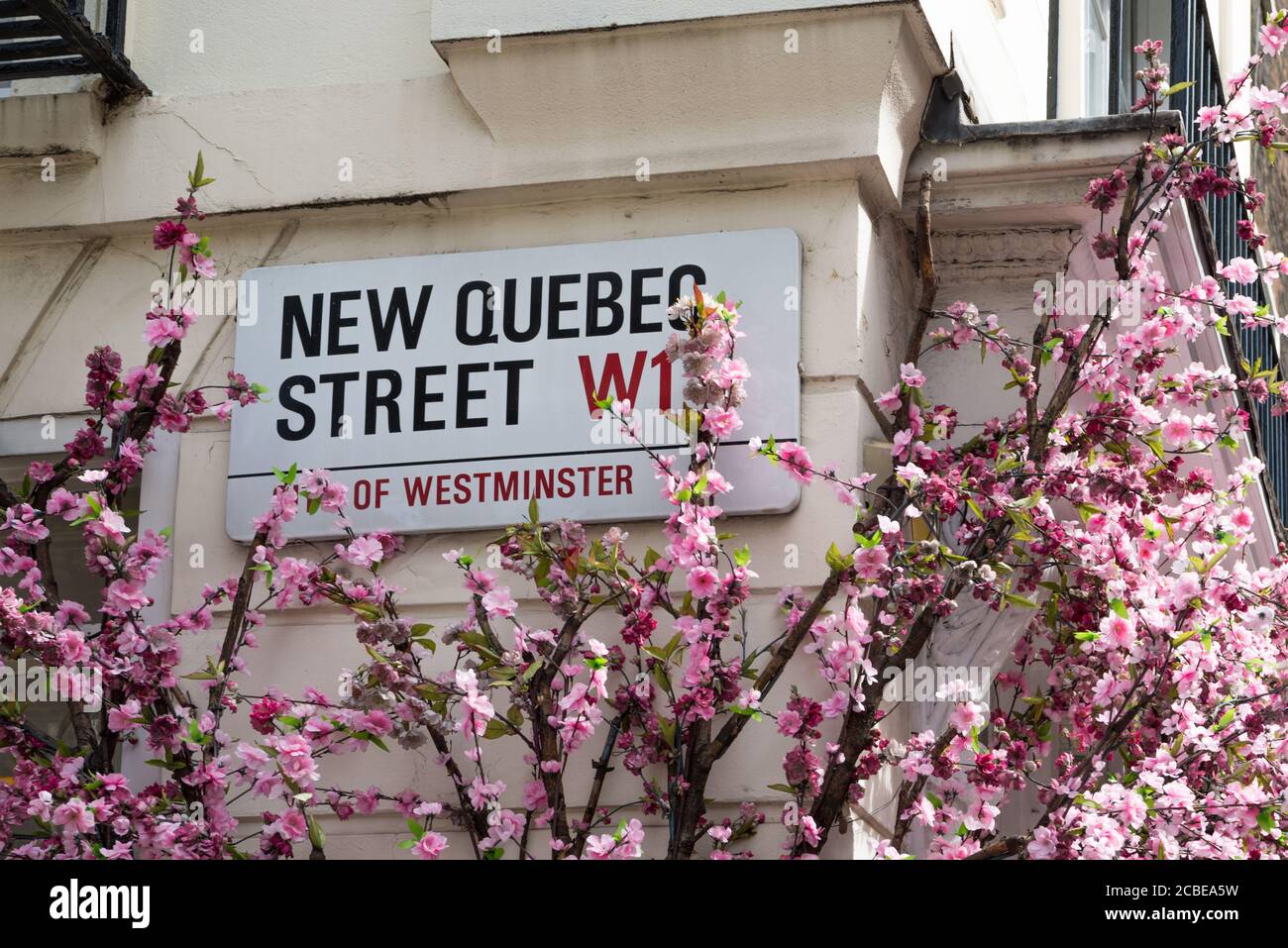 Plaque signalétique de la nouvelle rue du Québec sur le côté du bâtiment. Londres W1, Angleterre, Royaume-Uni Banque D'Images