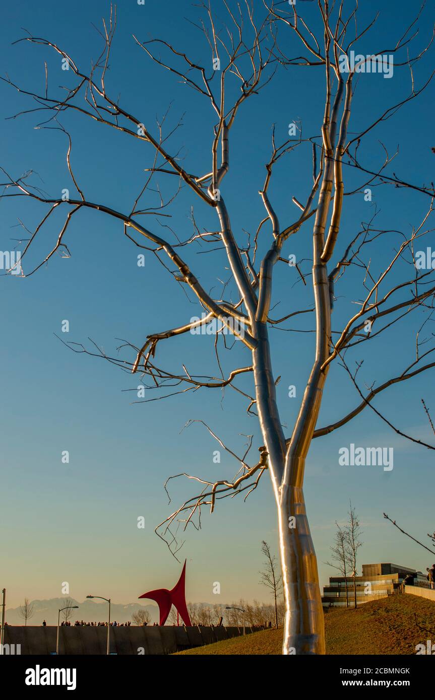 Une imposante sculpture d'arbre en acier inoxydable nommée Split par Roxy Paine avec l'aigle, sculpture d'art par Alexander Calder en arrière-plan aux Jeux olympiques Banque D'Images