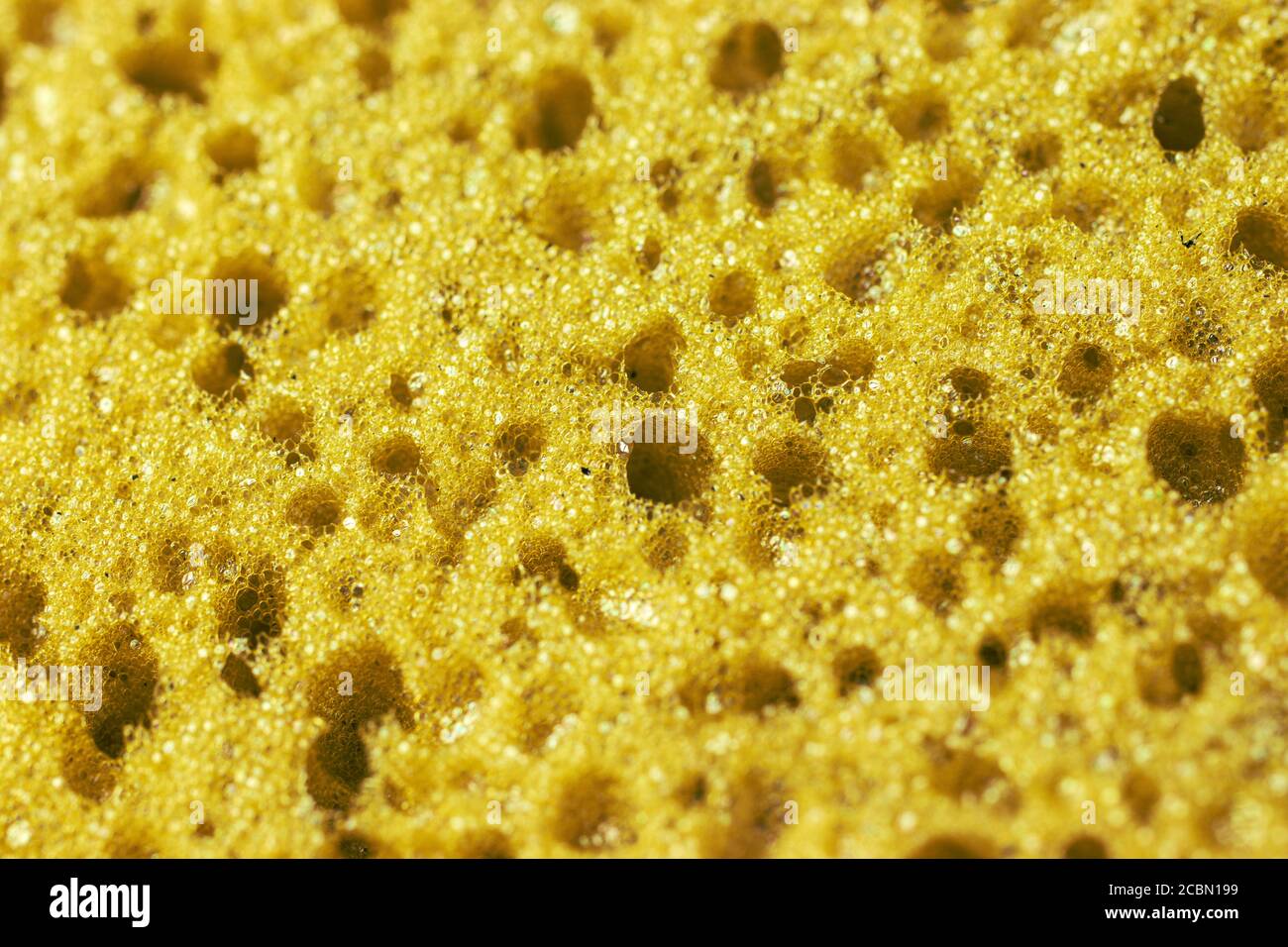 Fond de texture jaune avec trous. Photo macro Banque D'Images