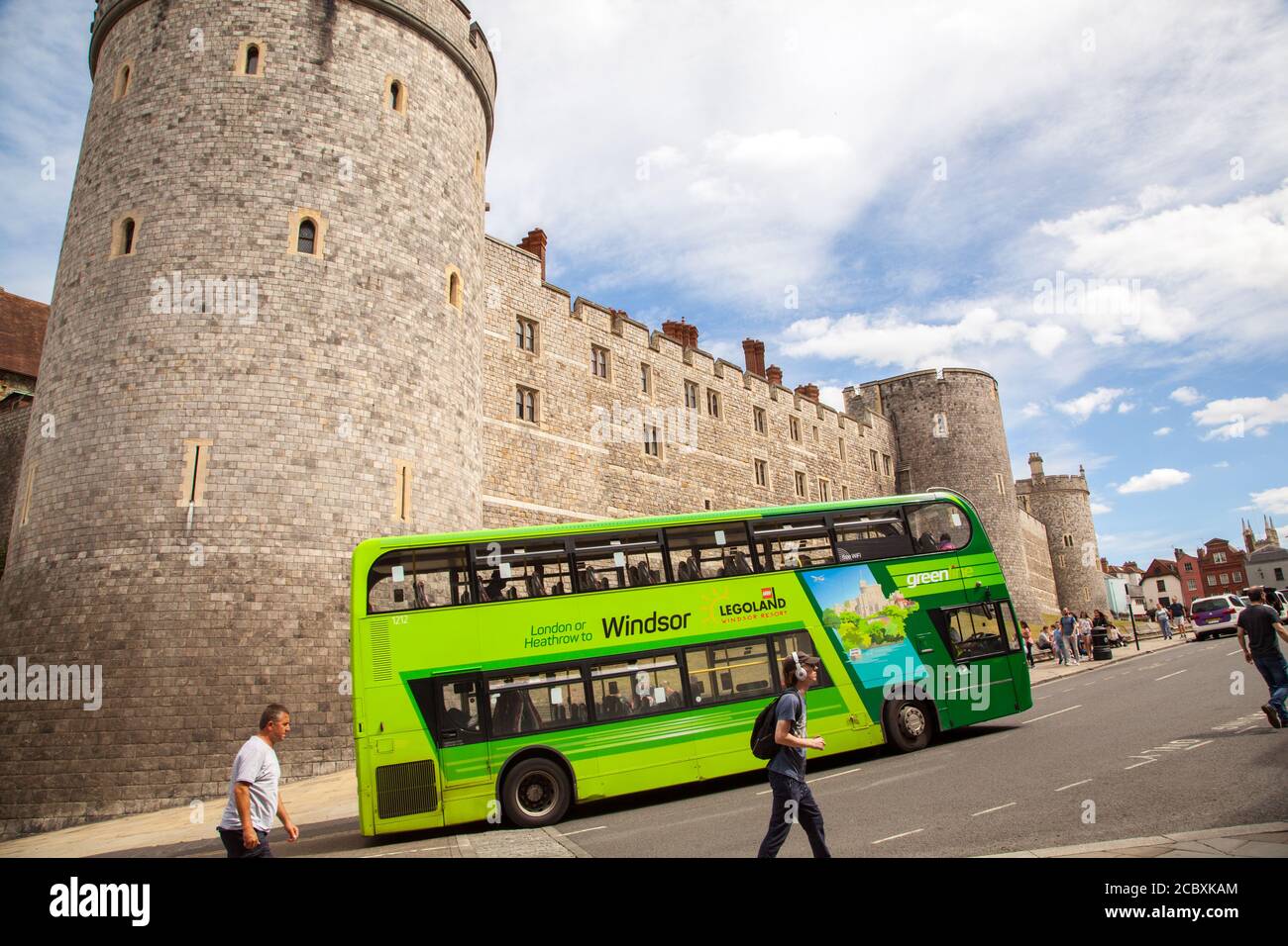 Bus à impériale vert passant devant le palais royal de Windsor, Angleterre, Royaume-Uni, demeure de la Reine Banque D'Images