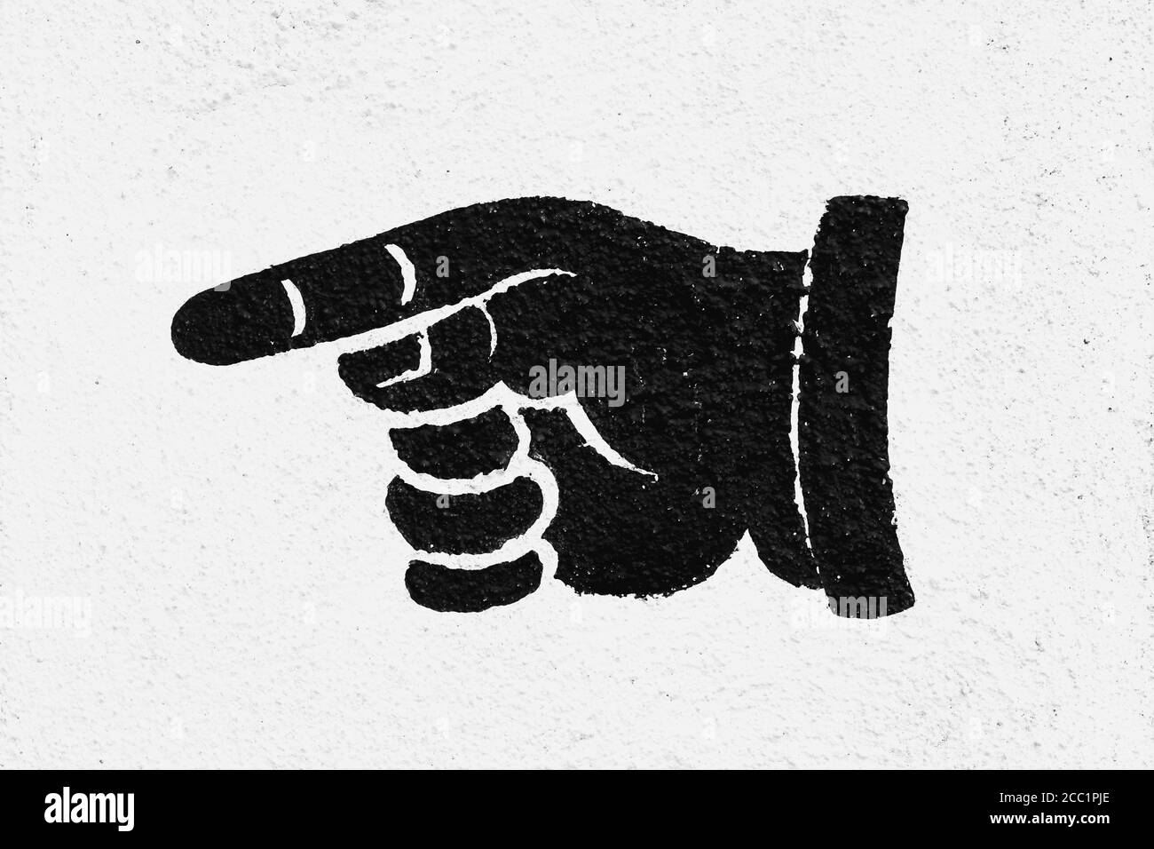 Main peinte en noir sur fond blanc avec le doigt pointé Banque D'Images
