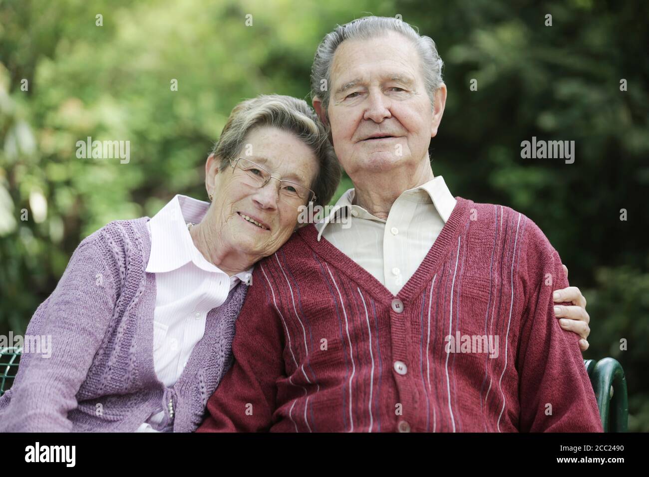 Allemagne, Cologne, Portrait of senior couple sitting in park, smiling Banque D'Images