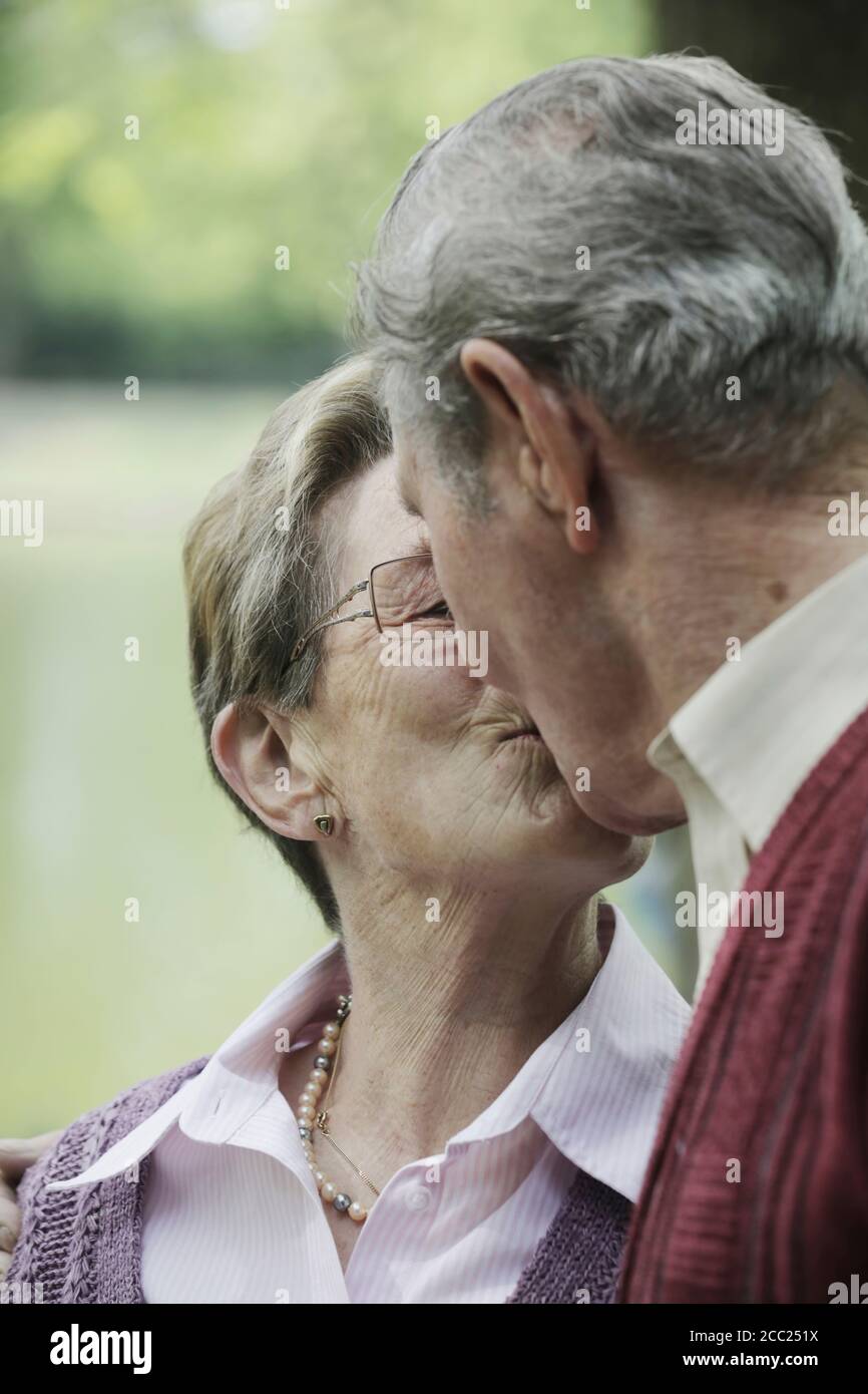 Allemagne, Cologne, Senior couple kissing in park Banque D'Images