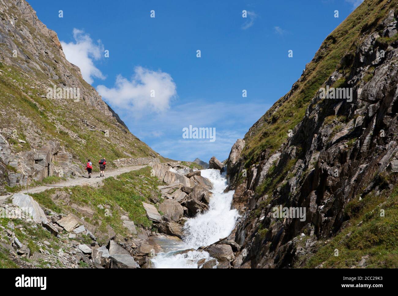 Italie, vue de Pfunderer Berge avec des randonneurs marchant près du ruisseau Banque D'Images