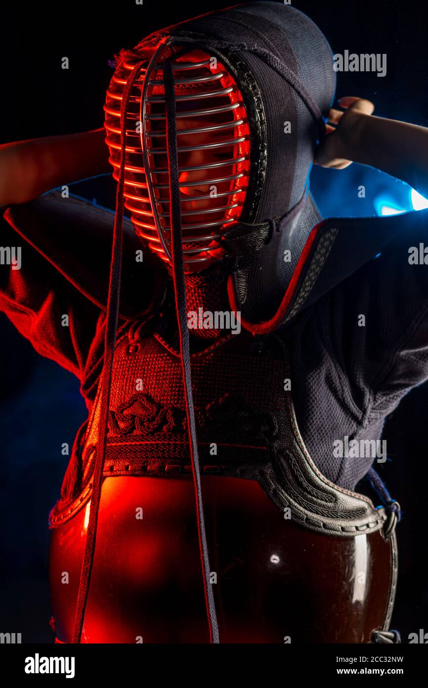 Kendo guru wearing in a traditional japanese kimono is practicing martial art wi
